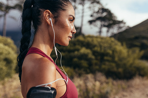 Woman athlete with earphones outdoors