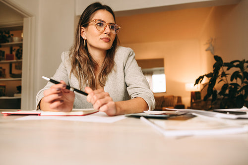 Thoughtful interior designer working in her home office