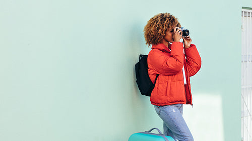 Woman tourist taking a photo standing outdoors
