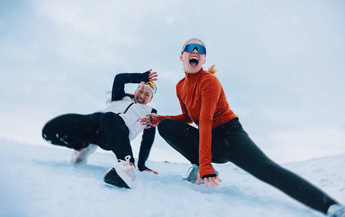 Women enjoying playful winter fun in the snow together
