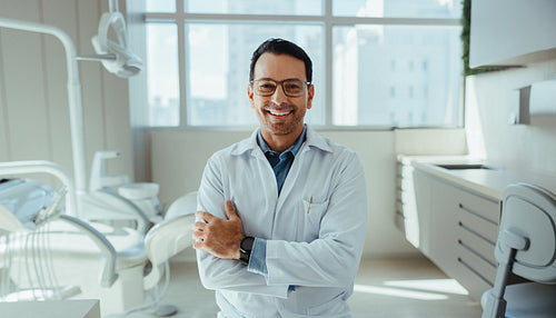Portrait shows dentist with confident healthcare presence in modern clinic
