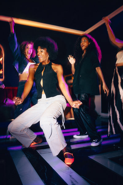 Young people dancing together at a lively nightclub experience