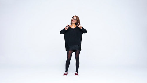 Smiling woman standing against white background