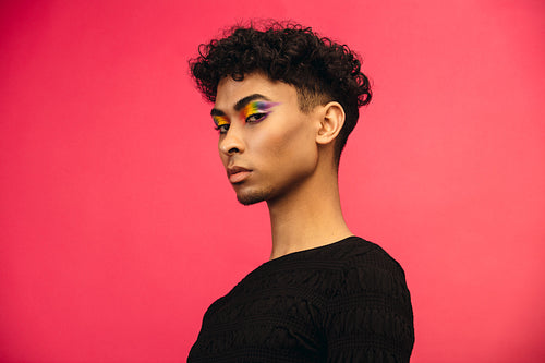 Handsome man with women’s makeup and clothing