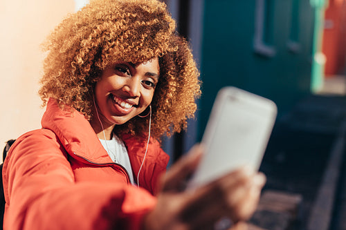 Smiling afro american tourist taking a selfie