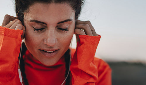 Female runner listening to music