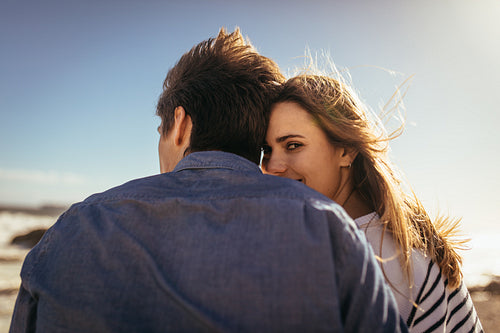 Romantic couple sitting together at the beach
