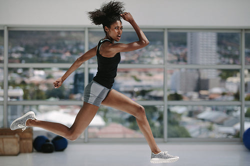 Female doing intense physical workout in fitness studio