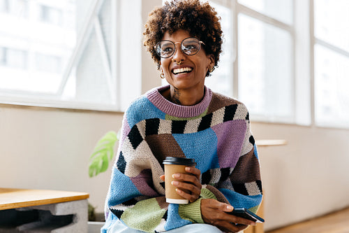 Freelance professional taking a coffee break in a bright co-working space