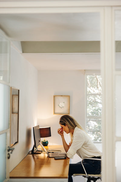 Exhausted businesswoman having a headache in an office