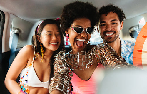 Friends celebrate Brazilian carnival in a festive car