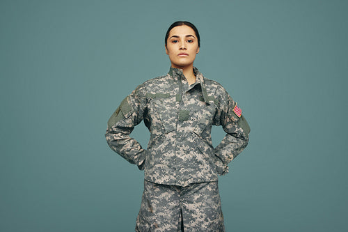 Young American army soldier standing in a studio
