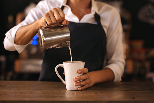 Professional barista preparing espresso on counter