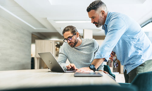 Modern businessmen working together in a co-working office