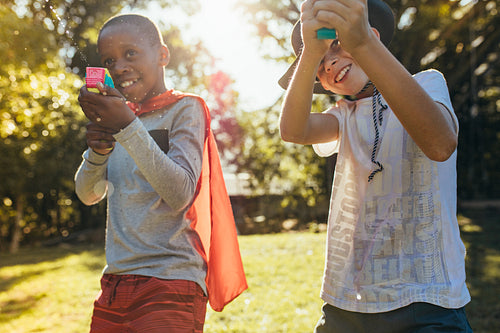 Kids playing with squirt guns outdoors