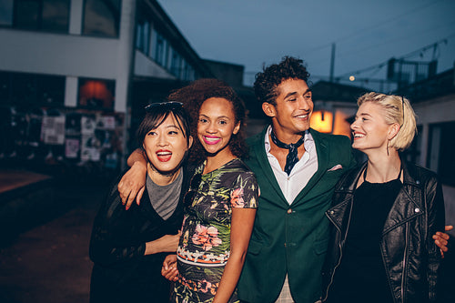 Friends walking down street in the evening