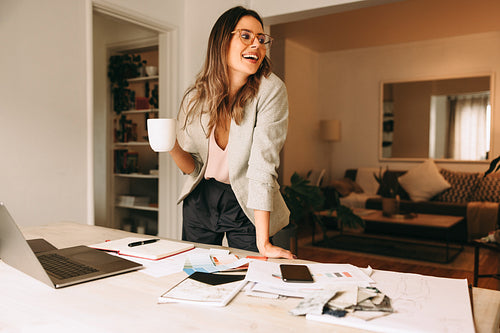 Design professional taking a coffee break in her home office