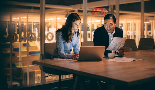 Business colleagues working late night in office