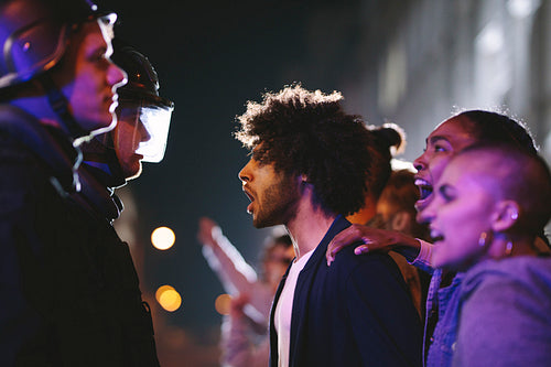 Angry protestors protesting in front of police force