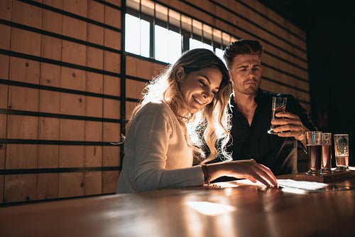 Couple at the bar tasting different varieties of craft beers