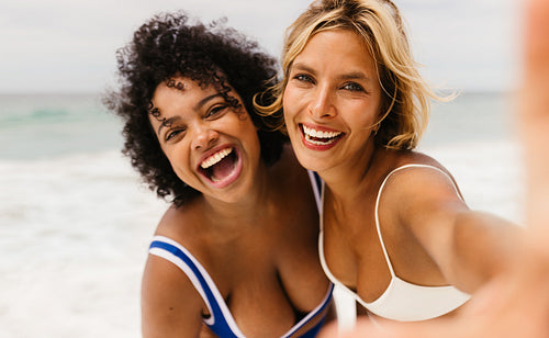 Beach selfie vibes: Friends capturing laughter, fun, and authentic moments by the ocean
