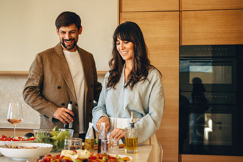 Couple cooking and enjoying time together in modern kitchen at home