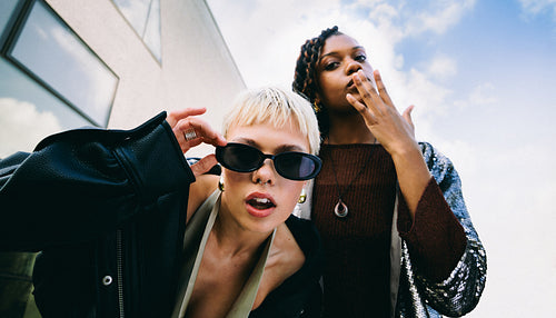 Urban friendship portrait, two women posing together outdoors
