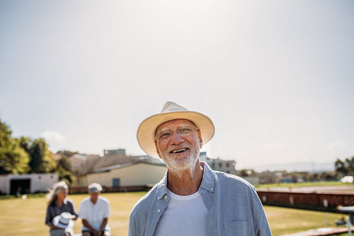 Close up of a senior man standing in a park