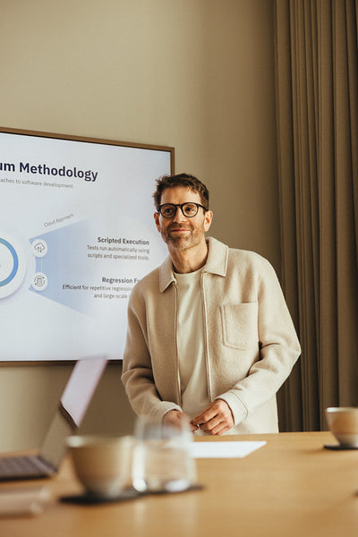 Man presents project management methods at team meeting