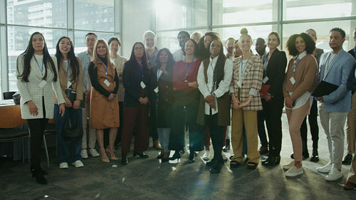 Happy business team waving together.