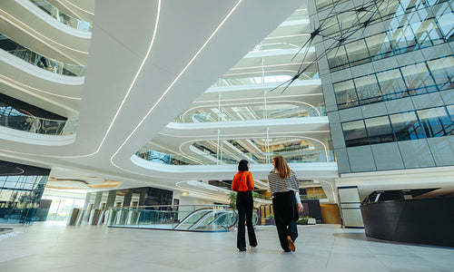Modern finance professionals walking through sleek lobby