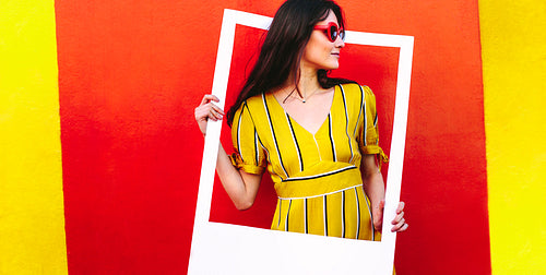 Beautiful woman with a blank picture frame