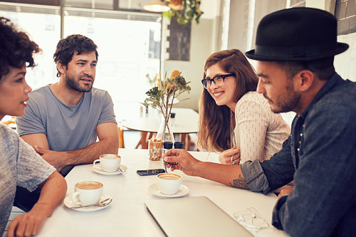 Friends having a discussion over a cup of coffee