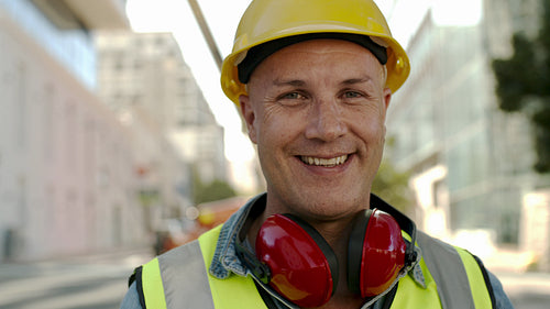 Smiling construction worker at site