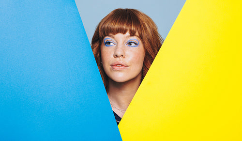 Woman standing with geometric shapes in a design studio
