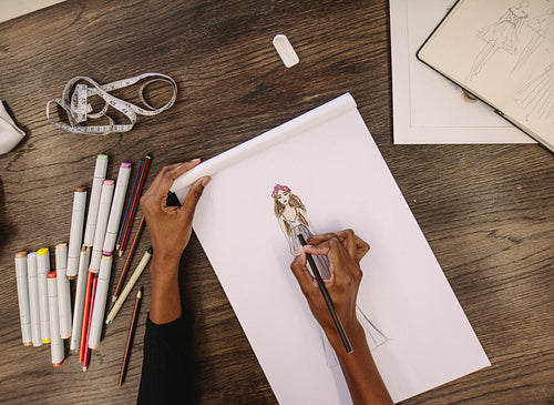 Fashion designer making a drawing in her studio