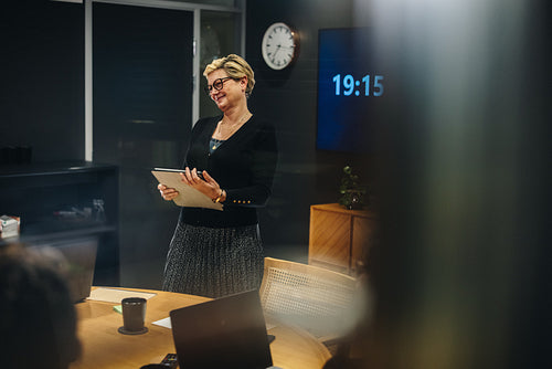 Happy businesswoman having a meeting with team