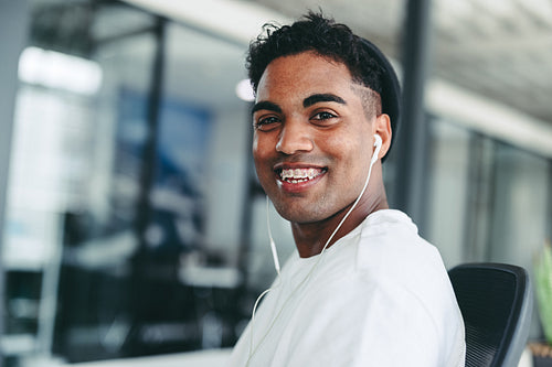 Businessman smiling cheerfully while sitting in an office