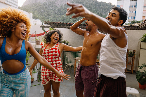 Dancing and celebrating under the hose during a summer gathering in Brazil