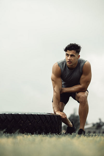 Muscular man taking break from cross training