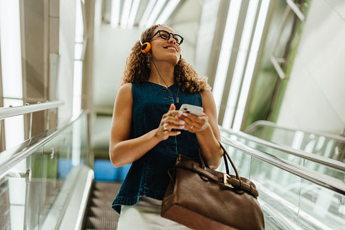 Listening to music on the escalator during city commute