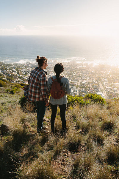 Hiking couple looking at the view from cliff