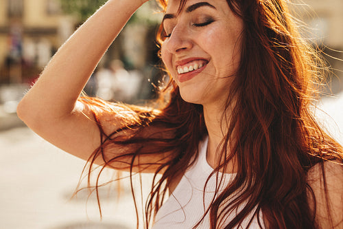 Woman with ginger hair enjoying herself in the city