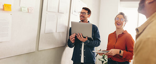 Happy businesspeople having a meeting in a creative workplace