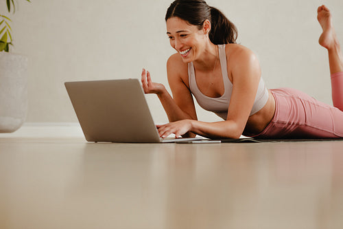 Fitness instructor communicating with class over video call