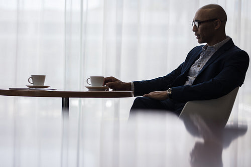 Businessman taking a coffee break at office