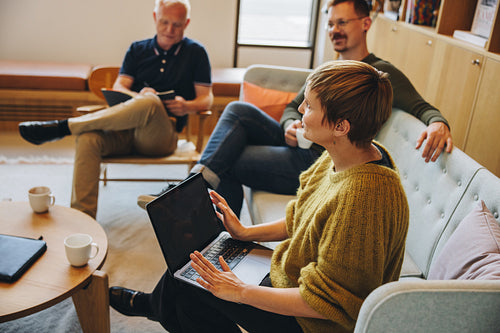 Businesswoman brainstorming new ideas with team