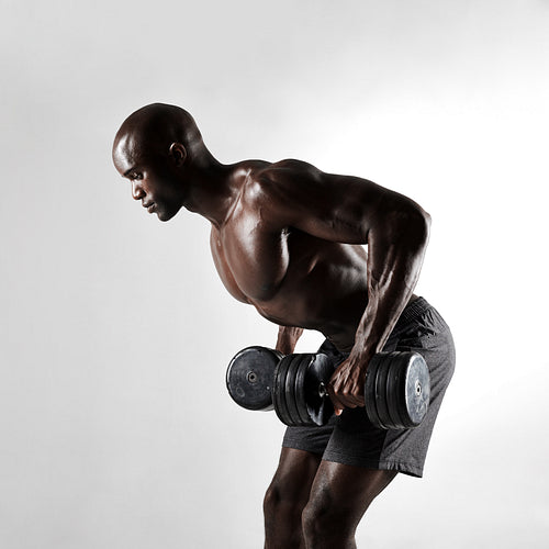 African bodybuilder exercising with dumbbells 