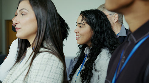Diverse group attentively watching presentation