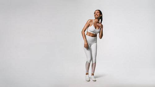 Smiling fit woman working out against white background